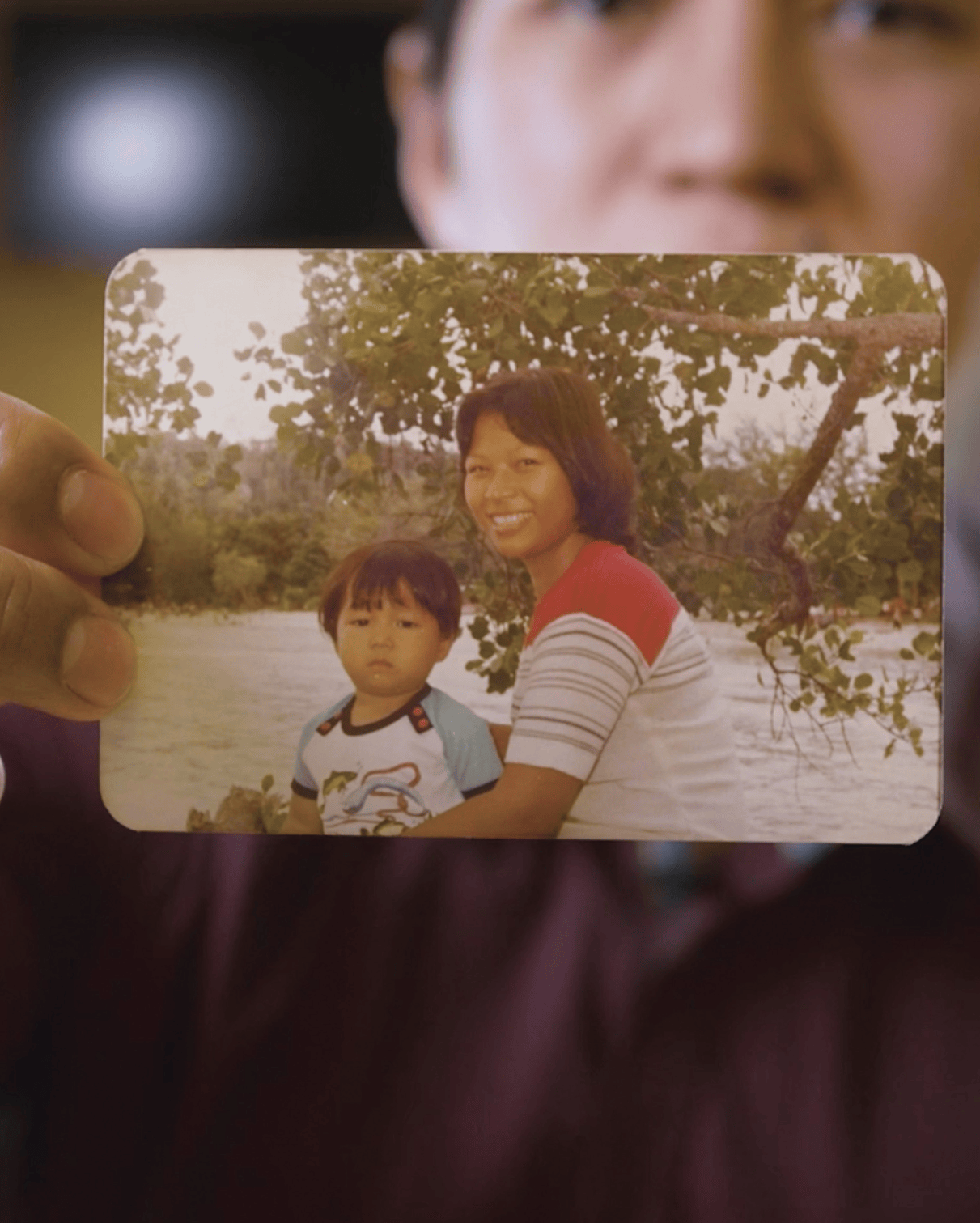 This is a photo of a team member holding a family photo.